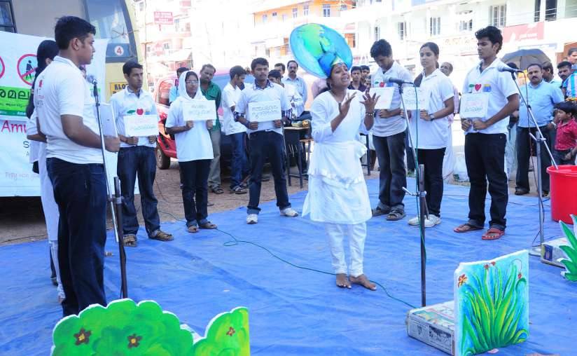 Volunteers performing a street play on waste