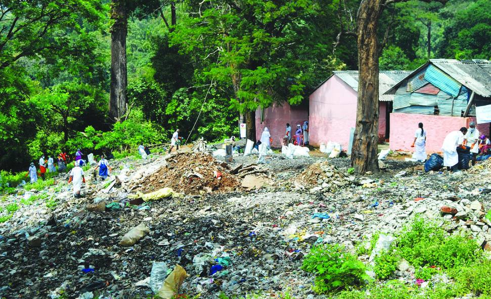 Before: waste covering ground beside buildings
