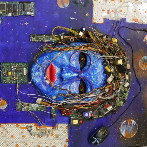 Artwork of a face made from electronic waste